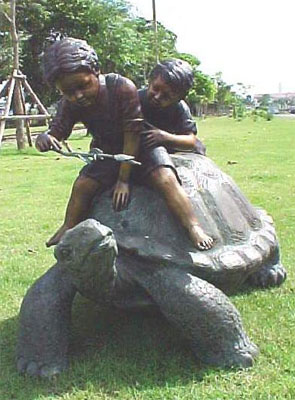 Two Boys Riding Turtle